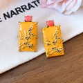 Detail showing yellow enamel rectangular earrings with gold floral relief and red stone - Gold / Yellow