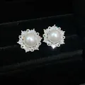 Close-up of elegant pearl earrings with sparkling zircon sunburst halo in a black velvet box - Sun Flower Style (WE5702) / Silver