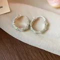 Detailed close-up of mint green enamel flower hoop earrings with silver-toned finish. - Huggie Earring (HE30850) / Light Cyan