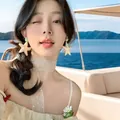 Asian model wearing oversized golden starfish earrings on a sunny yacht holiday - Matte Starfish Shape (13#)