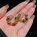 Macro view of vintage gold-plated hoop earrings featuring natural tiger eye stone beads - Ear Clip (Real Gold Plated) / Brown