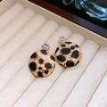 Elegant leopard print round stud earrings featuring leather wrap and crystal accents - Round (4)