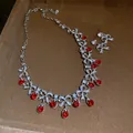 Elegant silver bowknot necklace and earring set featuring vibrant red teardrop crystals - Necklace and Earring Set / Silver-Red