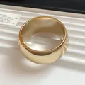 Detailed macro view of a chunky wide gold acrylic bracelet with a high gloss polished finish - Round / Large / Gold