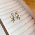 Detailed shot of vintage style floral pearl earrings presented in a velvet jewelry box. - 74# Silver Needle-Green-Leaf
