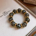 Close-up view of leopard print acrylic beads and gold spacers on a chic bracelet. - 12#