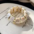 Chunky marbled beige and white resin bracelet with elegant gold-tone metallic dividers - Style 18 Bangle