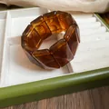 Detail of amber marbled acrylic chunky bracelet with rectangular segmented design. - 17#
