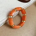 Chunky orange marbled acrylic square bead stretch bracelet with elegant gold spacers - Color 33