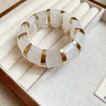 White marbled acrylic square bracelet with gold accents in a beige jewelry box tray - Style 36 Light Blue Floral