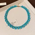 Detailed macro view of turquoise glass bead lace pattern with white teardrop accents. - 4# Necklace / Gold Blue White