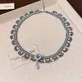 Detailed close-up of the beaded lace necklace featuring a blue stone and pearl pendant. - 7# Necklace / Blue