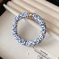 Stylish acrylic bracelet with black and white leopard print and gold metal accent piece - Style 53 Black Tropical Print