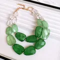 Close-up detail of double-layered green acrylic beaded necklace with irregular shapes. - Necklace / Green
