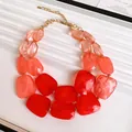 Detail shot of double-layer necklace with irregular vibrant red and orange acrylic beads - Necklace / Red