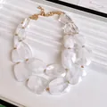 Detailed close-up of double-layer necklace with irregular white marbled acrylic beads - Necklace / White