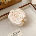 Detailed close-up view of an elegant cream fabric rose hair claw clip with satin texture - Claw Clip - White