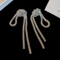 Elegant silver-toned chain-link knot tassel drop earrings with a metallic finish - Large / Silver