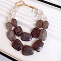 Detail of double-layered chunky necklace with marbled acrylic beads and gold chain. - Necklace / Black