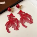 Detailed view of red hollow-out goldfish clip-on earrings with gold-tone hardware for women - Clip-on Earrings / Gold-Red