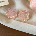 Macro view of pink gradient resin flower stud earrings with elegant glitter texture - Light Pink and Light Purple