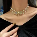 Elegant double-layer pearl choker necklace with a sparkling diamond bow pendant. - Gold Double Layer Bowknot Pearl Necklace (8#)
