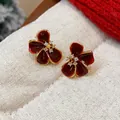 Macro view of dark red flower stud earrings with zircon center and fine gold plating - Flower Style (WE5277) / Ankara Red (Gold Plated)