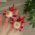 Festive Christmas reindeer antler hair clips featuring red ribbons and white pom-poms - Duckbill Hair Clips / Red