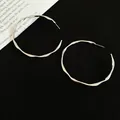 Silver-tone wavy hoop earrings with a modern twisted texture on a black background - 5cm / Distorted Ripples / Silver