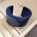 Close-up view of a bold cobalt blue resin open cuff bracelet resting in a jewelry box - Solid Color Wide Style (83#) / Dark Blue