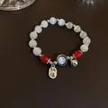 Handmade cat's eye beaded bracelet with red accents and lucky charm, elegant jewelry piece - Fortune Charm Style (31#)