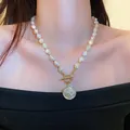 Elegant baroque pearl necklace with a vintage gold coin pendant shown on a model - Portrait Coin OT Buckle Necklace