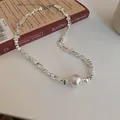 Retro silver beaded necklace featuring irregular metallic nuggets and a large white pearl focal point. - Geometric Irregular Necklace