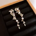 Elegant close-up of French vintage zircon and artificial pearl drop earrings on a black box - 13# Drop