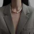 Close-up of a spliced necklace featuring white Baroque pearls and a gold rope chain - Spliced Pearl Necklace
