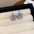Detailed macro view of exquisite sparkling zircon flower earrings in a velvet jewelry box - Earrings - White