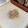 Detailed view of 18K gold plated hoop earrings with shimmering pavé set cubic zirconia - Gold