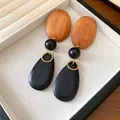 Close-up of vintage wooden drop earrings with black teardrop and tan oval accents - Colorblock Wood Dangle Earrings (77#) / Coffee-Black