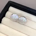Detailed view of silver-colored pleated texture earrings in a jewelry box slot. - Wrinkled Round Style (4)