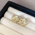 Macro detail of elegant gold-tone stud earrings with a stylish quilted textured design. - Grid Round Style (5)