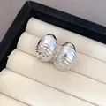 Macro view of silver-tone textured water-drop earrings in a jewelry box - Wrinkled Long Drop (8)