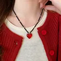 Elegant red agate heart pendant necklace worn by a model with a stylish red cardigan. - 6# Necklace-Gold-Red