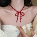 Exquisite red agate beaded bow necklace on female model, festive holiday jewelry - 22# Necklace-Red
