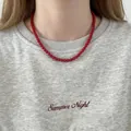 Elegant red agate bead necklace worn as a choker accessory over a casual grey sweatshirt - Style 13 - Red Agate - 6mm
