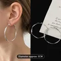 Detailed view of large 5cm twisted silver hoop earrings with a sleek minimalist design. - Large / Irregular Twisted Hoop Style (44) / Silver