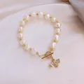 Close-up detail of a baroque pearl bracelet featuring a sparkling zircon bee charm - Little Bee Freshwater Pearl Bracelet