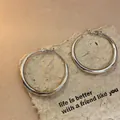 Polished silver chunky oval hoop earrings on textured kraft paper background - Medium / Simple Oval Hoop Style (51#) / Silver