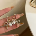 Eleganti orecchini a fiocco dorati con perle bianche e strass di cristallo scintillanti - 不对称蝴蝶结珍珠耳钉(19#)