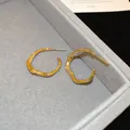 Elegant irregular gold plated oval hoop earrings featuring a unique liquid metal texture - Wave Irregular Oval Hoop (60#) / Gold