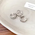 Close-up of three irregular silver ear cuffs with hammered and smooth textures - Irregular Round Style / Silver Ear Cuffs (3-Piece Set)